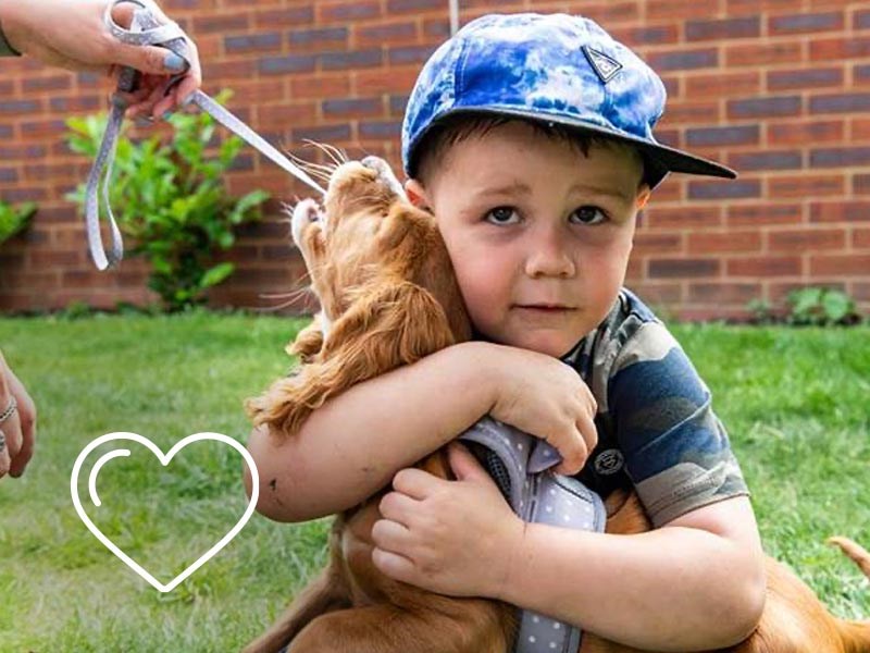 Image of small boy hugging puppy