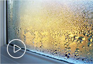 Window with condensation with white play button icon overlaying