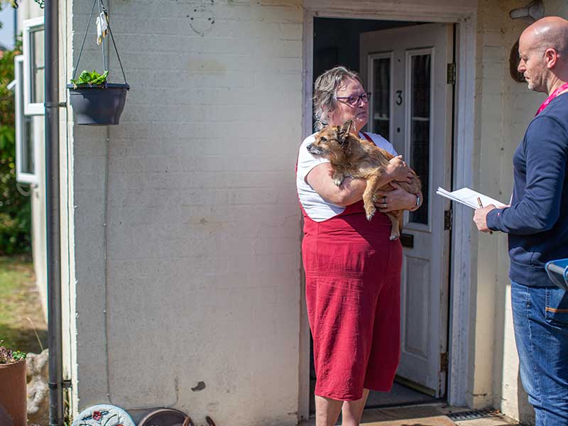 Customer outside her home with her dog