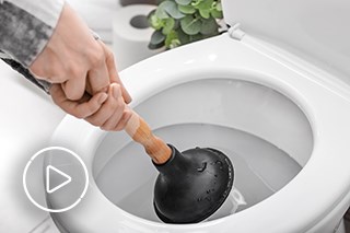 Image of person using plunger to unblock sink