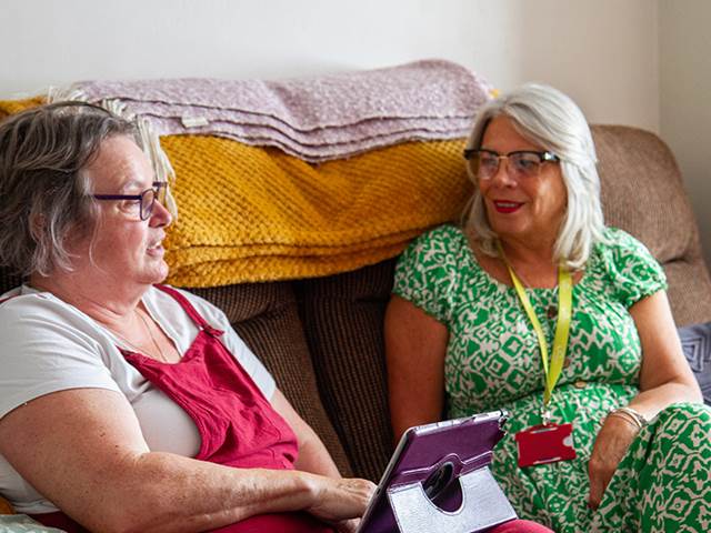 Two people talking on the sofa