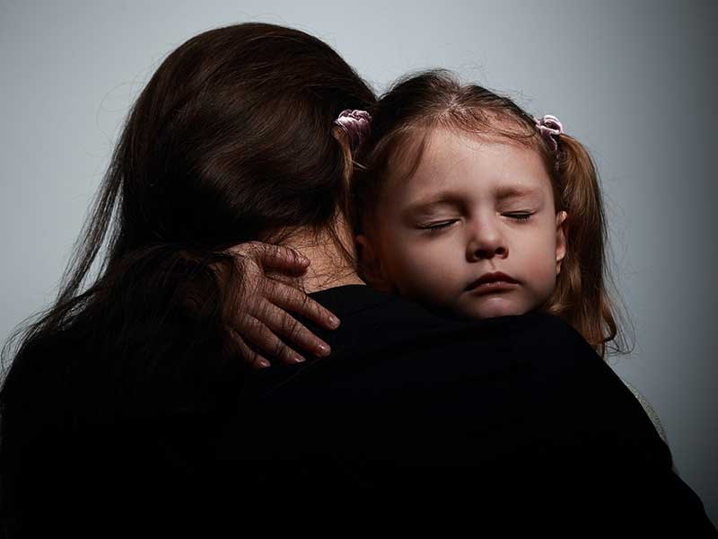Image of small girl hugging women