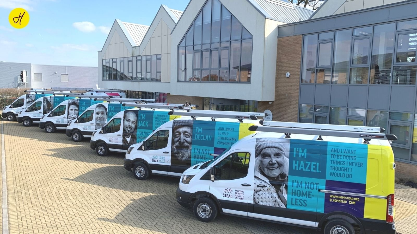 Image of Hopestead charity vans parked outside building