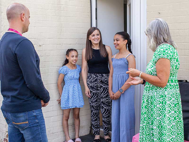 Family outside a house